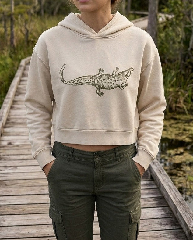 Mineral Washed Crop Hoodie in Light Apricot with vintage alligator graphic, front view, shown on a model.